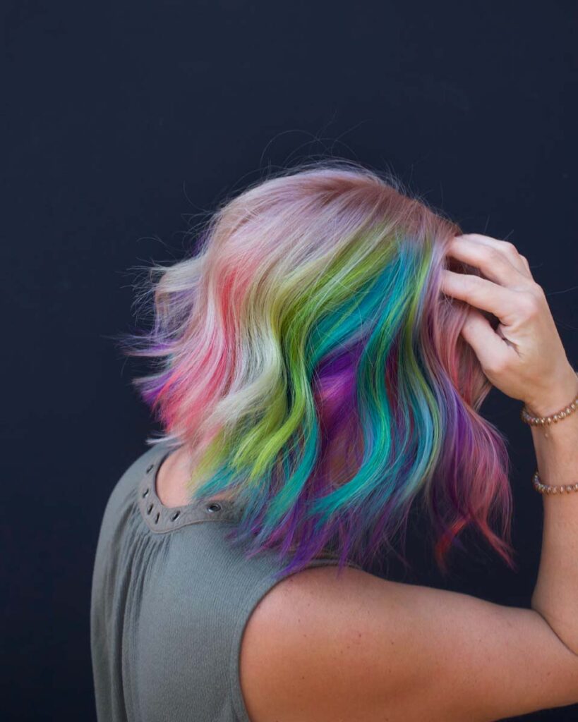 a woman with rainbow colored hair blue mesa salon Loveland Co